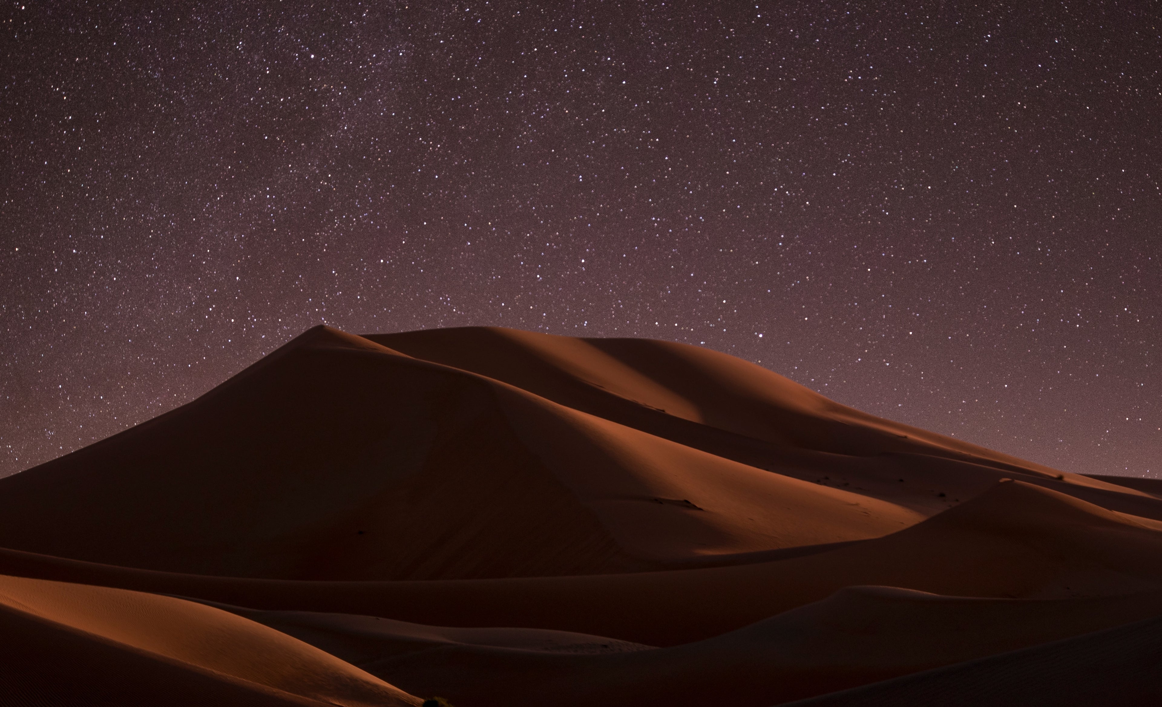 image of sand dunes at night with lots of stars showing